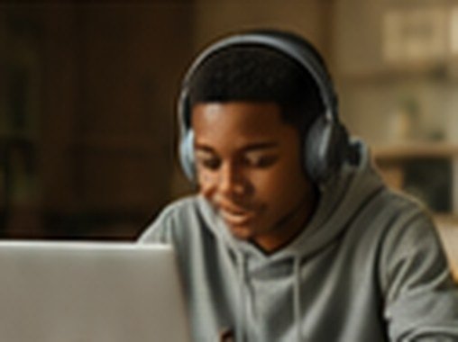 Student in headphones attending a live online lesson